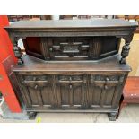 A 20th century oak court cupboard with a rectangular top above a central cupboard above three