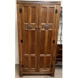 A 20th century oak hall robe, with carved panelled doors on stiles,