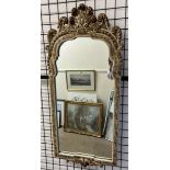 A gilt and cream wall mirror with feather carving to the top