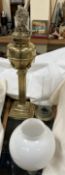 A Victorian Brass oil lamp with a square reeded column and square sloped base