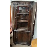 A 20th century oak standing corner cupboard,