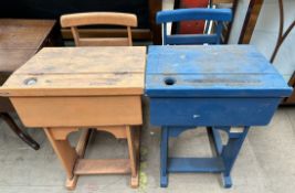 A pair of school desks with integrated chairs, one painted orange,