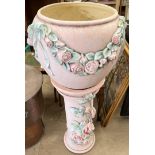 A pottery jardiniere and stand decorated with roses and leaves