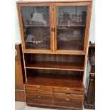 A mid 20th century Danish wall unit, the top section with a pair of glazed doors,