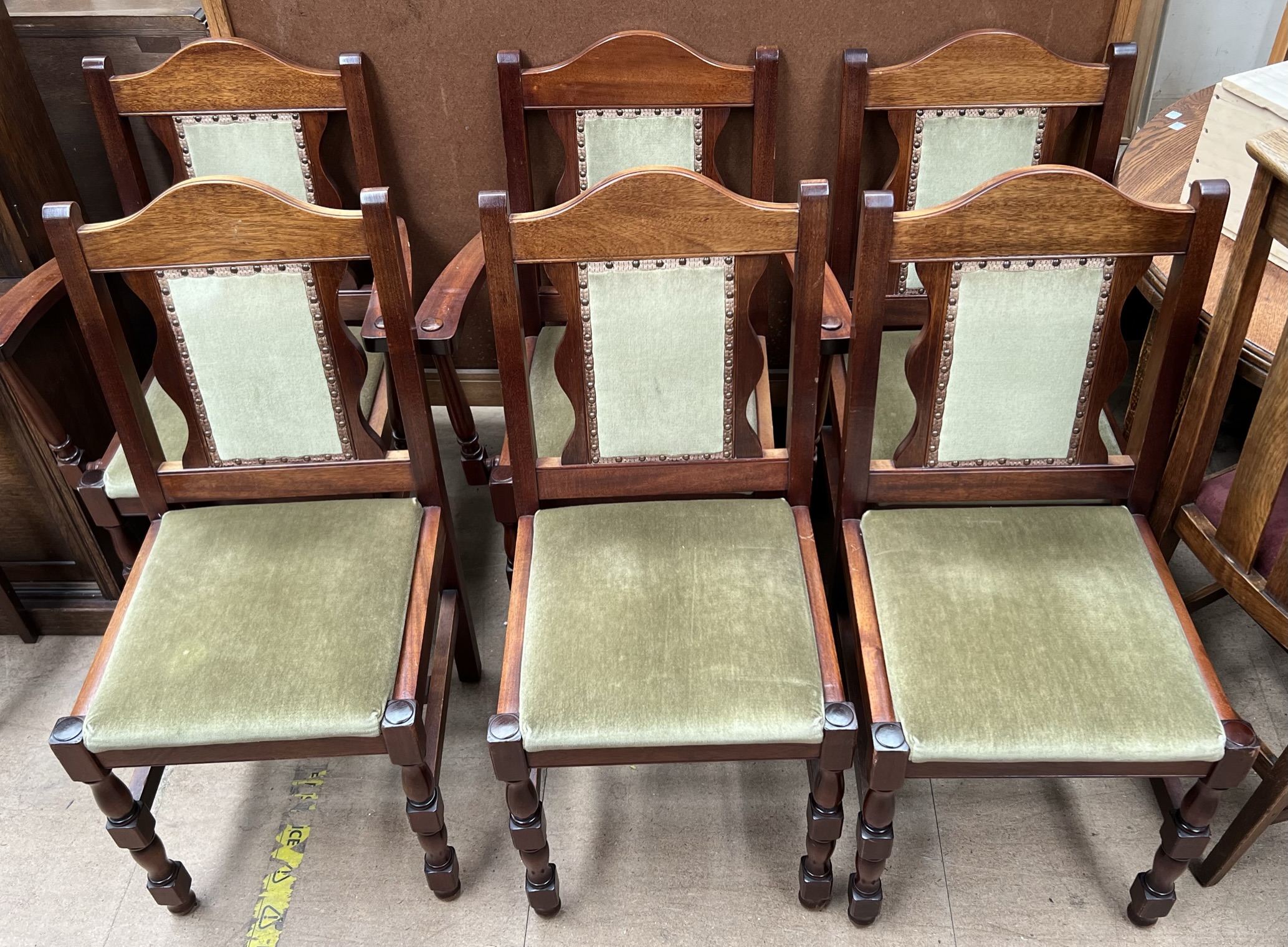 A set of six modern dining chairs with pad upholstered seats and backs on turned legs