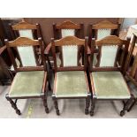 A set of six modern dining chairs with pad upholstered seats and backs on turned legs