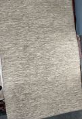 A cream leather floor rug,