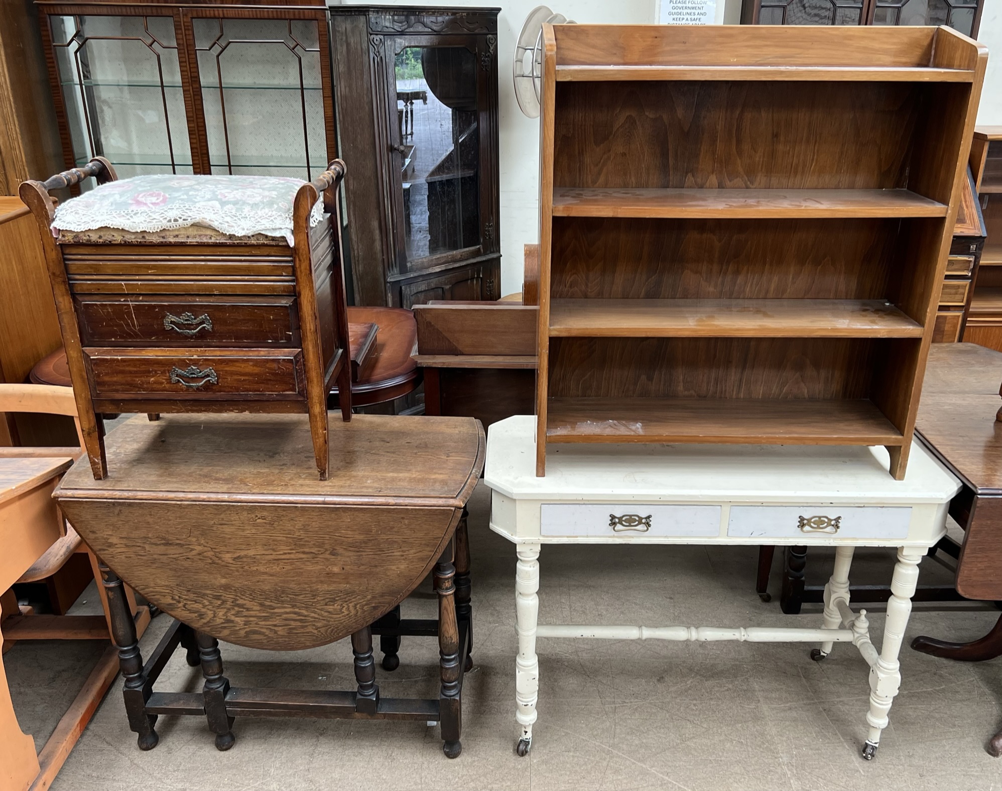 A 20th century oak gateleg dining table together with a piano stool,