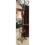 A bentwood hat and coat stand together with a brass standard lamp