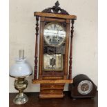 A drop dial wall clock together with an oak mantle clock and a brass and glass oil lamp