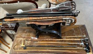 A leather topped folding stool together with assorted walking sticks