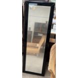 A black framed full length easel mirror