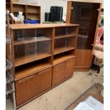 A pair of Meredew teak bookcases together with a teak standing corner cupboard