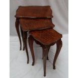 A nest of three French Louis XV style kingwood, parquetry and gilt metal mounted occasional tables,