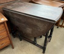 An oak gateleg dining table with drop flaps on ring turned legs ***PLEASE NOTE THAT THIS LOT WILL