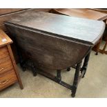 An oak gateleg dining table with drop flaps on ring turned legs ***PLEASE NOTE THAT THIS LOT WILL