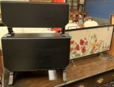 An Edwardian ebonised two tier Sutherland table together with an embroidered fire screen