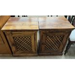 A pair of hardwood side cabinets with rectangular top above slatted doors on a plinth