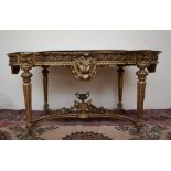 A French carved giltwood and gesso centre table with a shaped white marble top,