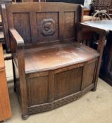 A 20th century oak monks bench with a foldover back