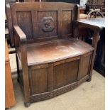 A 20th century oak monks bench with a foldover back