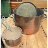 A large copper cooking pot together with a copper saucepan and lid and a brass tray