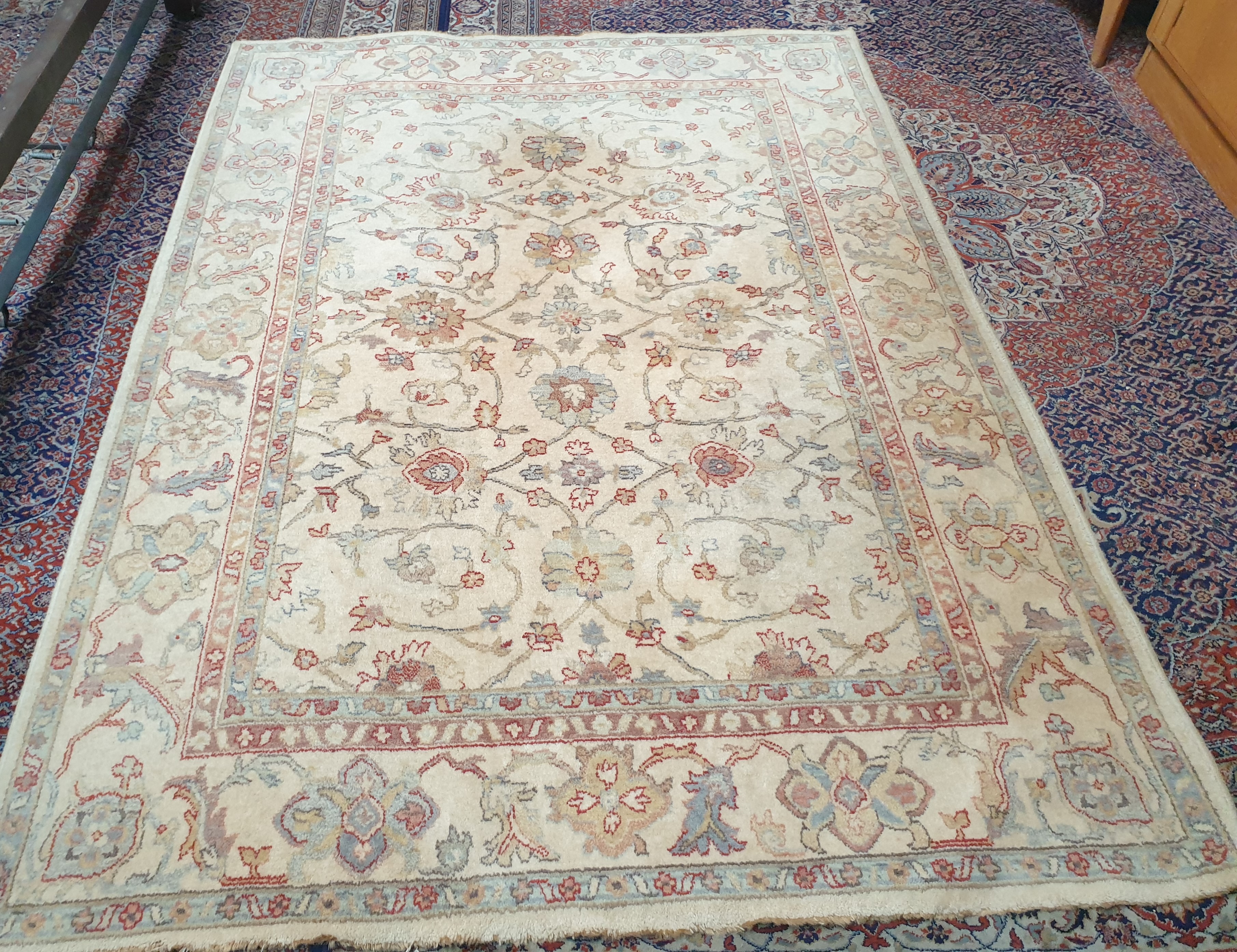 A modern cream ground rug with interlaced flowers