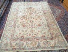 A modern cream ground rug with interlaced flowers