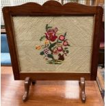 A mahogany framed fire screen with an embroidered panel of a squirrel and flowers ***PLEASE NOTE