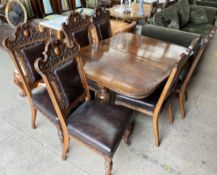 A late Victorian / Edwardian oak dining suite comprising an extending dining table and six chairs