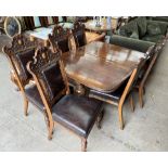 A late Victorian / Edwardian oak dining suite comprising an extending dining table and six chairs