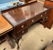 A 20th century mahogany dressing table with five drawers on shell capped cabriole legs and pad feet