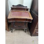 An early 20th century mahogany Davenport with a stationery compartment and sloping writing fall