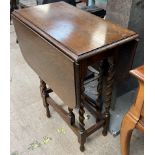 An oak gate leg table with barley twist legs