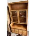 A Nathan teak side cabinet with a pair of glazed doors,