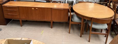 A McIntosh teak sideboard together with a dining table and four chairs
