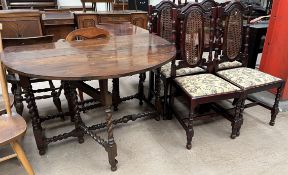 A 19th century gateleg table with an oval top and drop flaps on barley twist legs together with