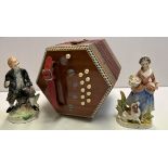 A Hohner concertina together with a pair of continental pottery figures
