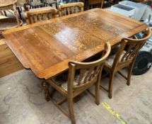 A 20th century oak extending dining table and four chairs