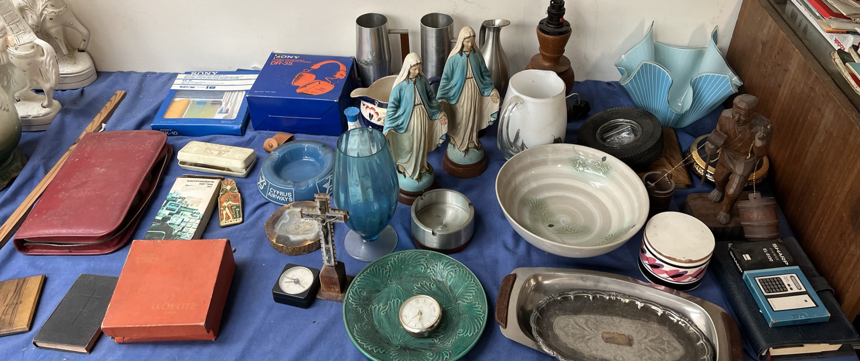 Pewter tankards together with Virgin Mary figures, glass handkerchief vase,