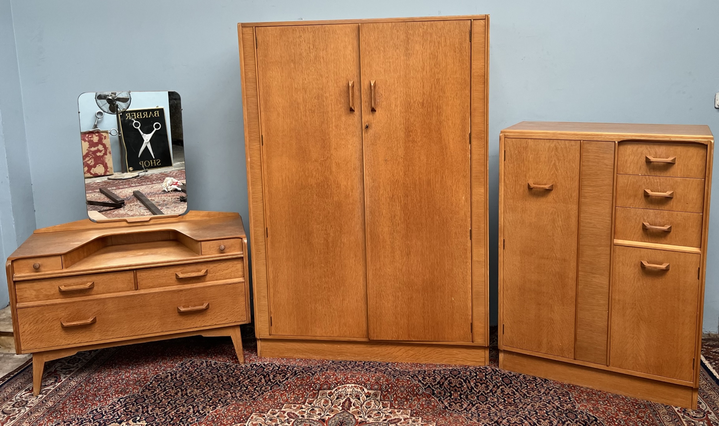 A G-Plan E Gomme oak bedroom suite comprising a wardrobe,