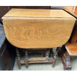 An oak table with drop flaps and barley twist legs