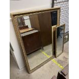 A large gilt framed wall mirror of rectangular form together with a smaller rectangular mirror