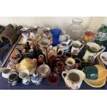 Graduated pottery jugs together with glass decanters, novelty teapots,