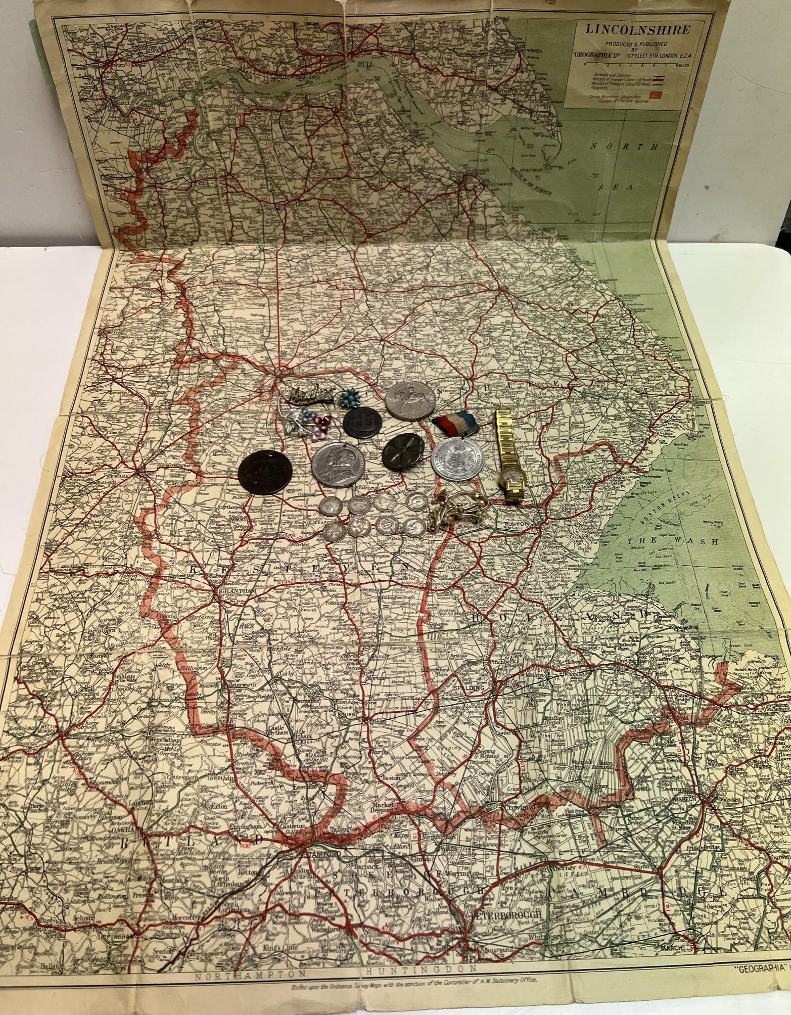 A map of Lincolnshire together with Silver 3d coins,