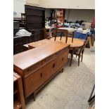 A mid-20th century G-Plan teak dining suite comprising an extending dining table,