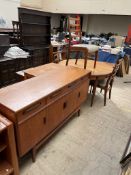 A mid-20th century G-Plan teak dining suite comprising an extending dining table,