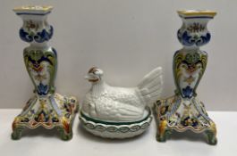 A pair of delft pottery candlesticks together with a pottery chicken and basket