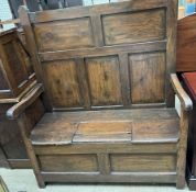 A 19th century pine box settle, with a panelled back,