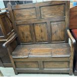 A 19th century pine box settle, with a panelled back,